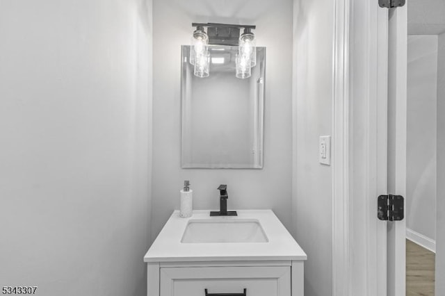 bathroom with wood finished floors and vanity