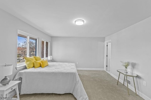 carpeted bedroom featuring baseboards