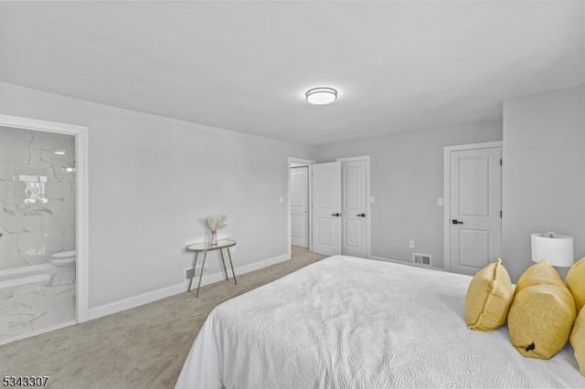 bedroom featuring carpet flooring, baseboards, visible vents, and connected bathroom