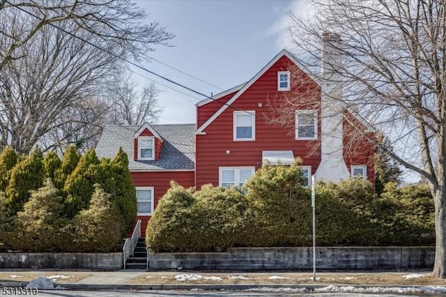 exterior space featuring roof with shingles