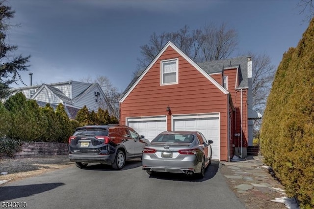 exterior space featuring aphalt driveway and a garage