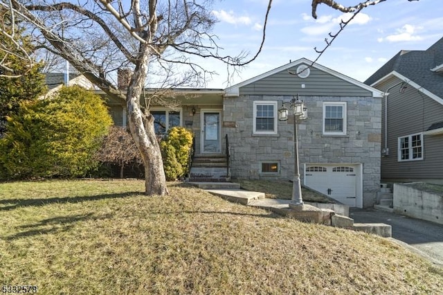 view of front of home featuring aphalt driveway, stone siding, a front yard, an attached garage, and a chimney