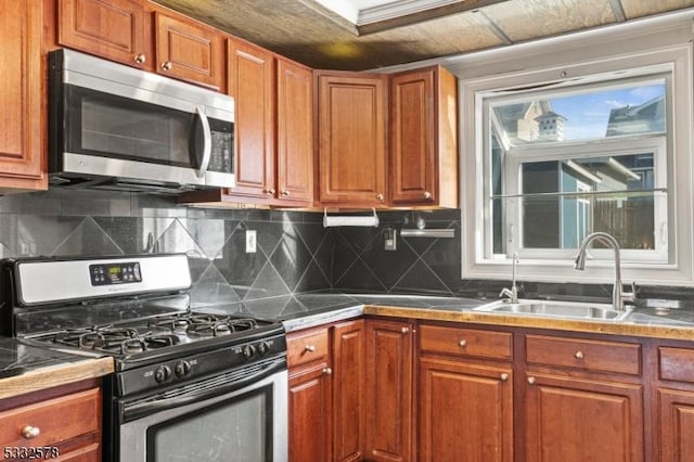 kitchen featuring a sink, brown cabinets, and stainless steel appliances