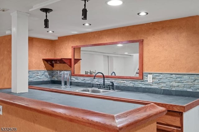 bar with recessed lighting, tasteful backsplash, and a sink