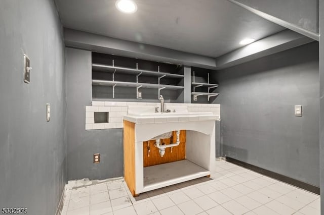 interior space featuring a sink and baseboards