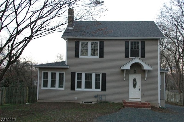 view of front of property featuring entry steps and a chimney