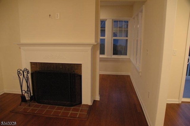 room details with a fireplace, baseboards, and wood finished floors