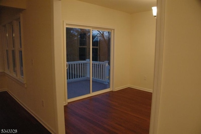 interior space with baseboards and wood finished floors