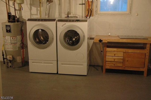 laundry room with gas water heater, washer and clothes dryer, and laundry area