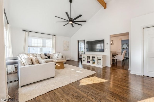 living area featuring baseboards, beamed ceiling, wood finished floors, high vaulted ceiling, and a ceiling fan