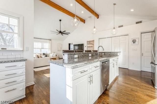 kitchen featuring visible vents, a sink, beam ceiling, appliances with stainless steel finishes, and dark wood-style flooring