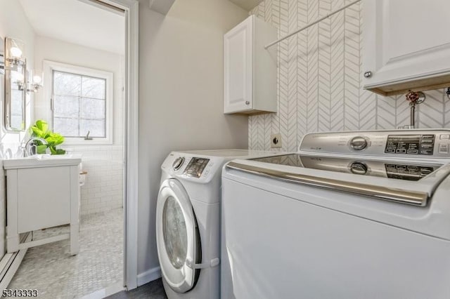 laundry area with a sink, cabinet space, and washing machine and clothes dryer