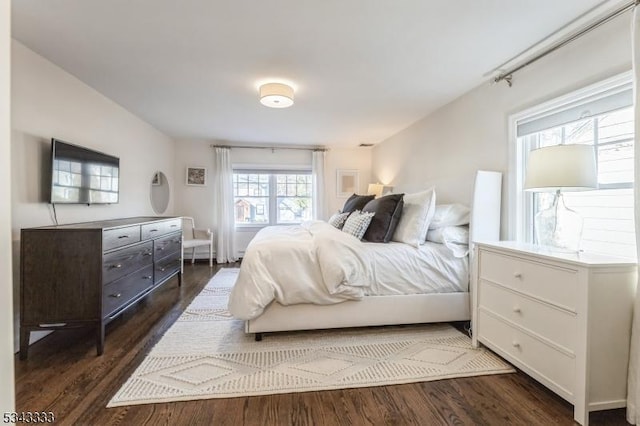 bedroom with dark wood-type flooring