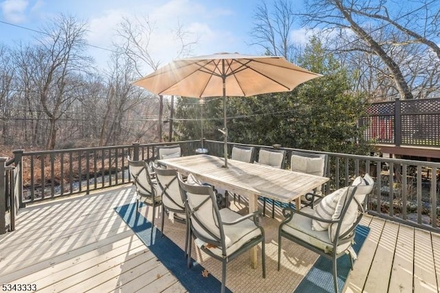 wooden deck featuring outdoor dining area