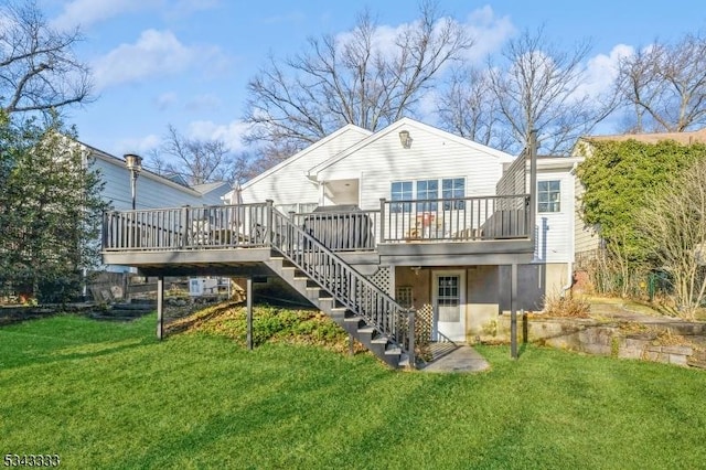 back of property featuring stairway, a yard, and a deck