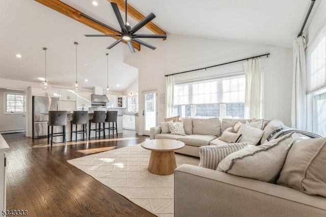 living area with beam ceiling, wood finished floors, high vaulted ceiling, a ceiling fan, and a baseboard radiator