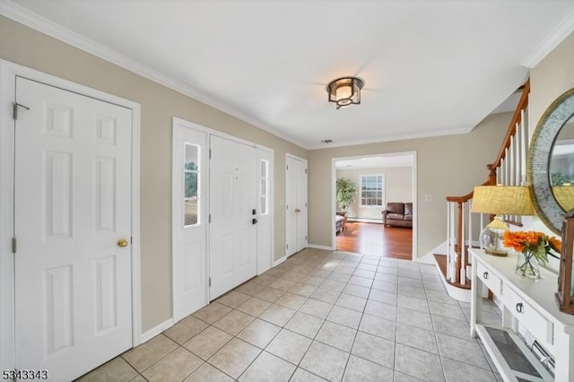 entryway with stairway, baseboards, light tile patterned flooring, and crown molding