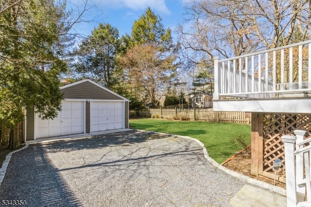 exterior space with an outbuilding, a garage, and fence