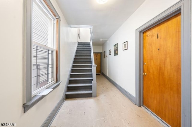 staircase featuring baseboards