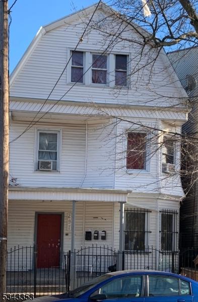 view of front of property with a fenced front yard and a porch