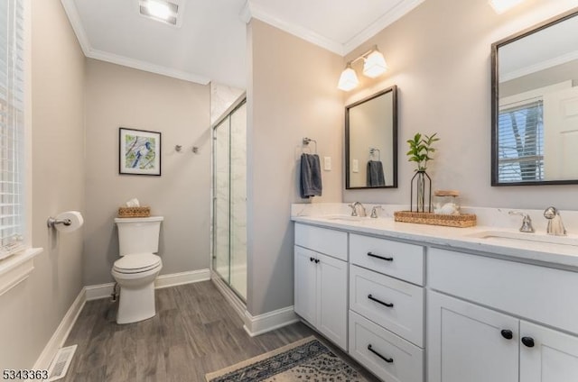 bathroom with a sink, a stall shower, and crown molding