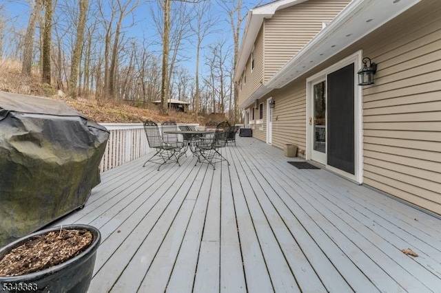 wooden terrace featuring outdoor dining space