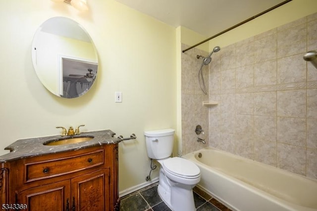 bathroom featuring tile patterned floors, toilet, washtub / shower combination, baseboards, and vanity