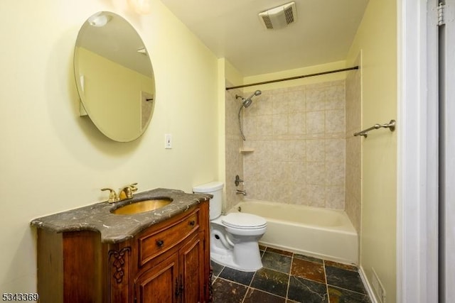 bathroom with vanity, visible vents,  shower combination, stone tile flooring, and toilet