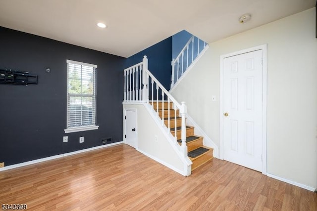 staircase with visible vents, recessed lighting, baseboards, and wood finished floors