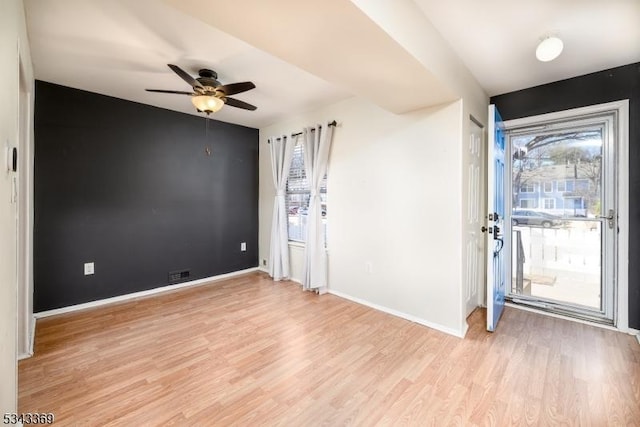 entrance foyer featuring visible vents, a ceiling fan, light wood-type flooring, and baseboards