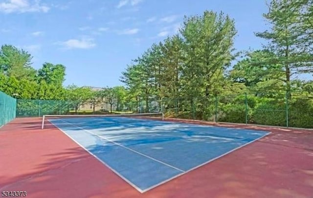 view of sport court featuring fence