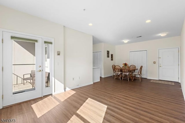 dining space with recessed lighting, wood finished floors, and baseboards