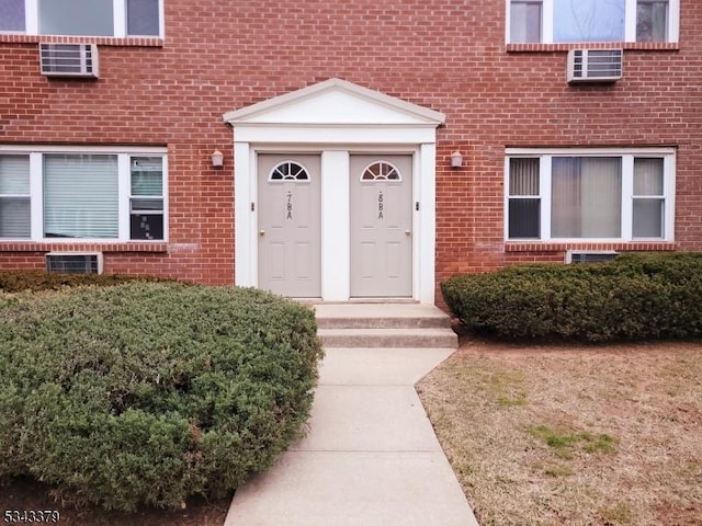 doorway to property featuring brick siding