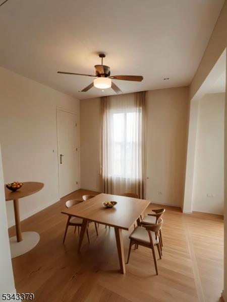 dining room with breakfast area, light wood finished floors, and ceiling fan