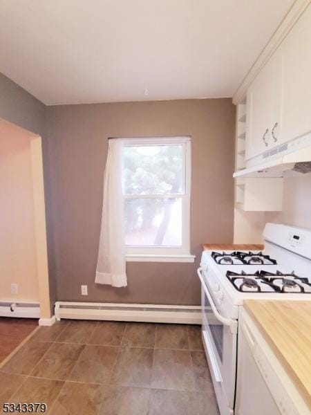 kitchen with under cabinet range hood, a baseboard radiator, white range with gas stovetop, and white cabinets