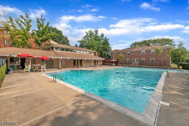 pool featuring a patio area and fence