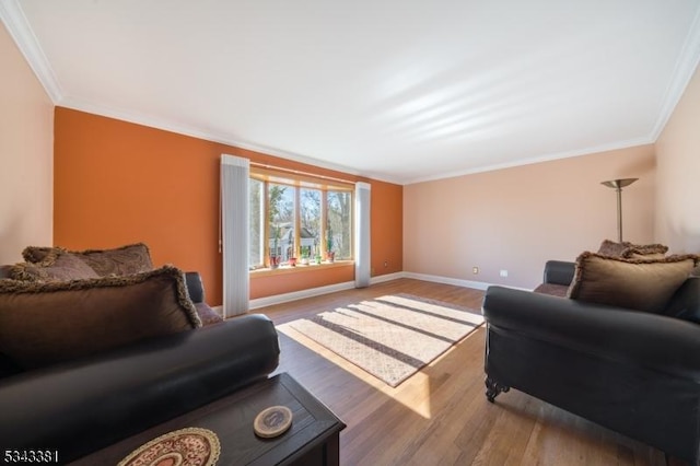 living room with baseboards, wood finished floors, and crown molding