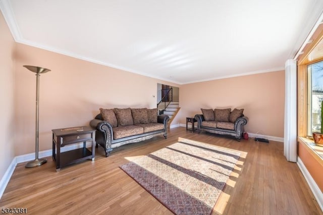 living area with stairs, light wood-style floors, and baseboards