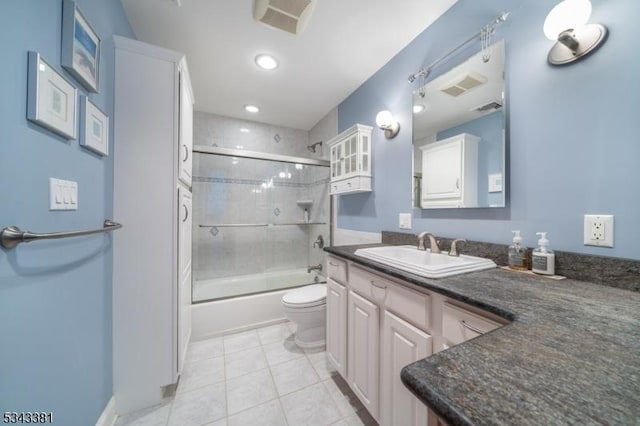 bathroom featuring visible vents, toilet, tile patterned flooring, bath / shower combo with glass door, and vanity