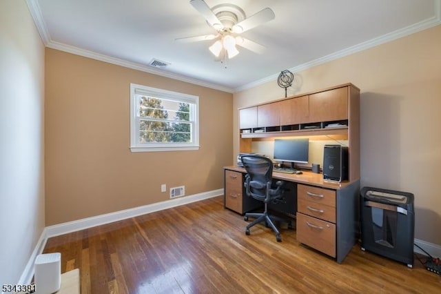 office with visible vents, ornamental molding, and wood finished floors