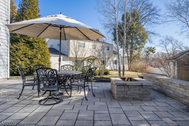 view of patio / terrace with an outdoor fire pit and outdoor dining area