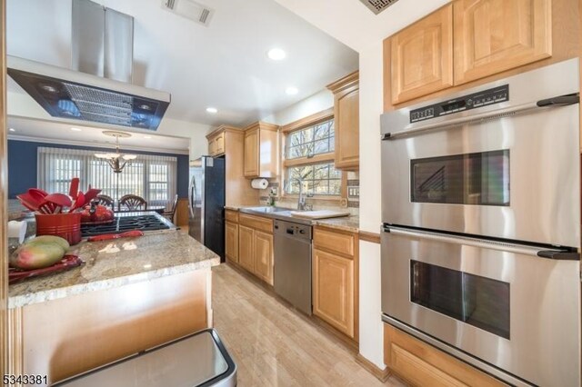 kitchen featuring island range hood, light brown cabinets, visible vents, and stainless steel appliances