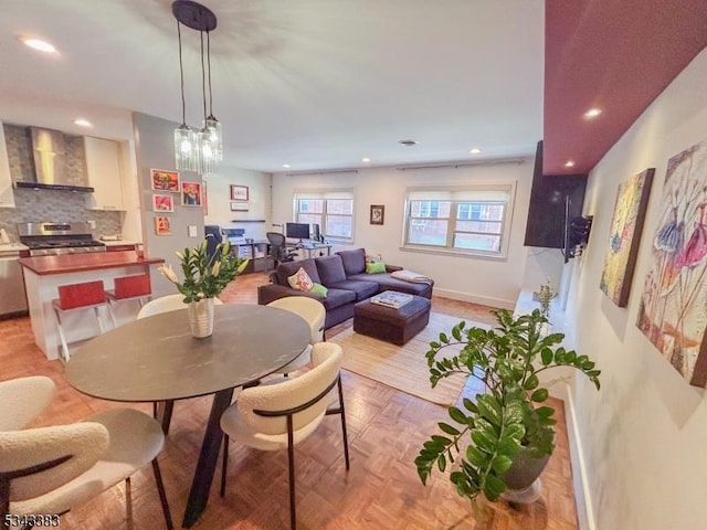 dining room with recessed lighting and baseboards