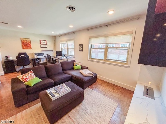 living room featuring recessed lighting, baseboards, and visible vents