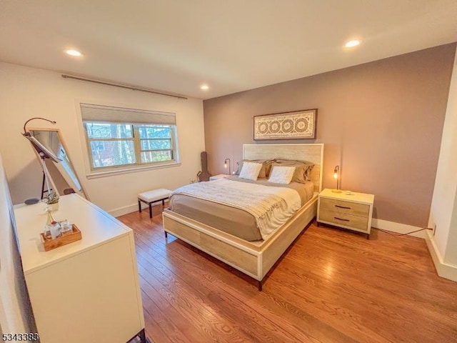 bedroom with recessed lighting, baseboards, and wood finished floors