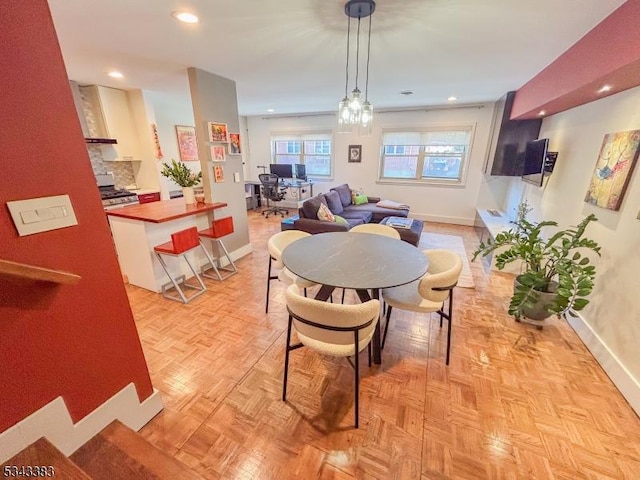 dining area featuring recessed lighting and baseboards