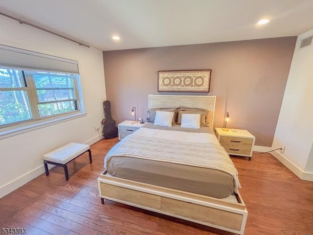 bedroom featuring recessed lighting, wood finished floors, and baseboards