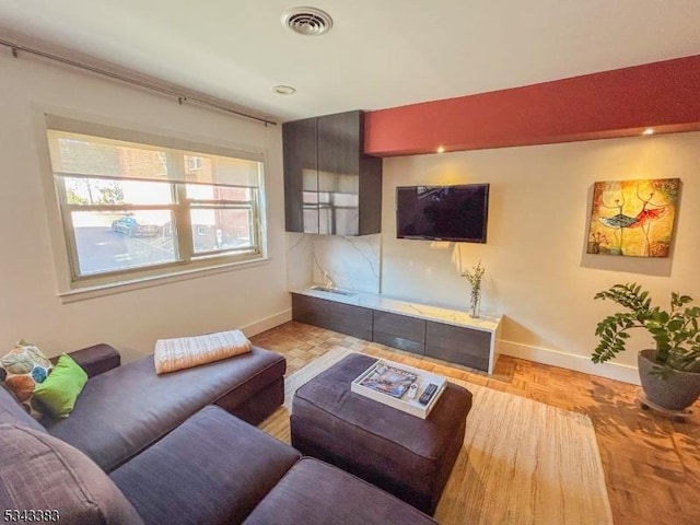 living area featuring visible vents and baseboards