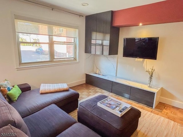 living area featuring baseboards