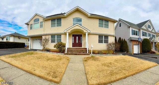 view of front of house featuring aphalt driveway and an attached garage